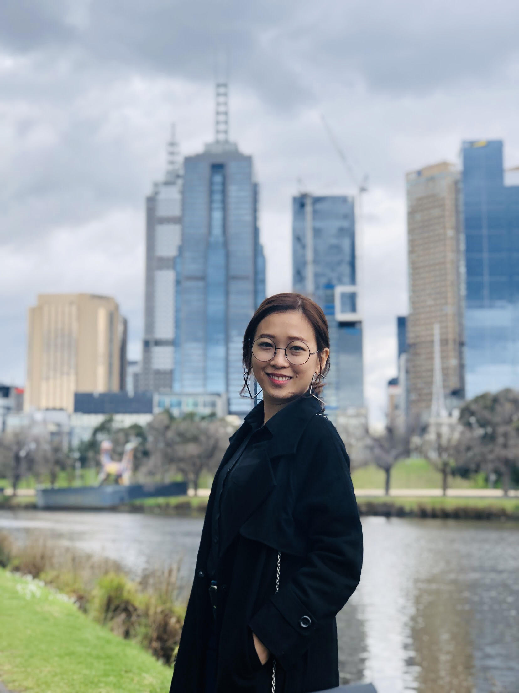 Shanice Huei standing in front of a city skyline